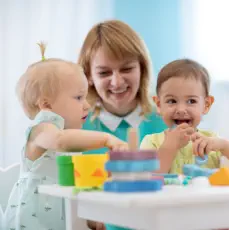 A femlae baby sitter playing with two kids