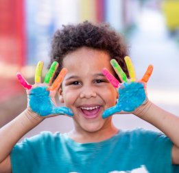 A child showing his hands with paint