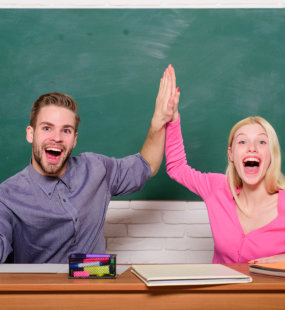 two person laughing together showcasing a friendly environment